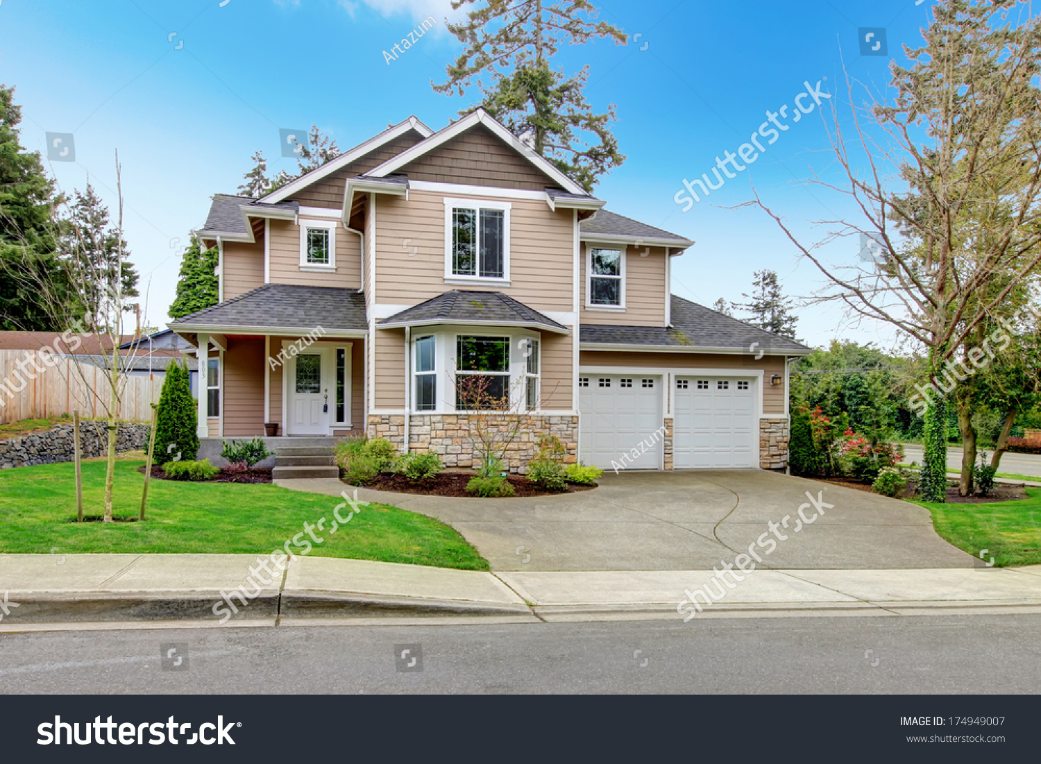 stock-photo-siding-house-with-tile-roof-enclosed-garage-and-beautiful-curb-appeal-174949007